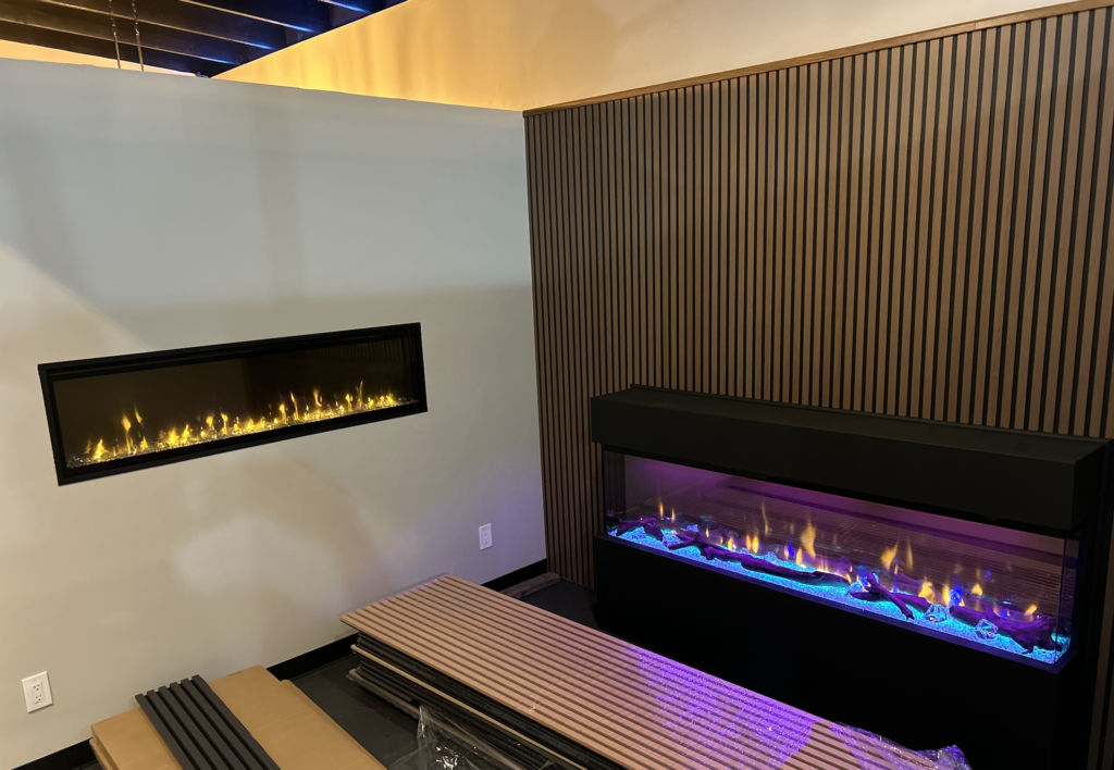 two electric fireplaces being installed in fureplace store mesa az